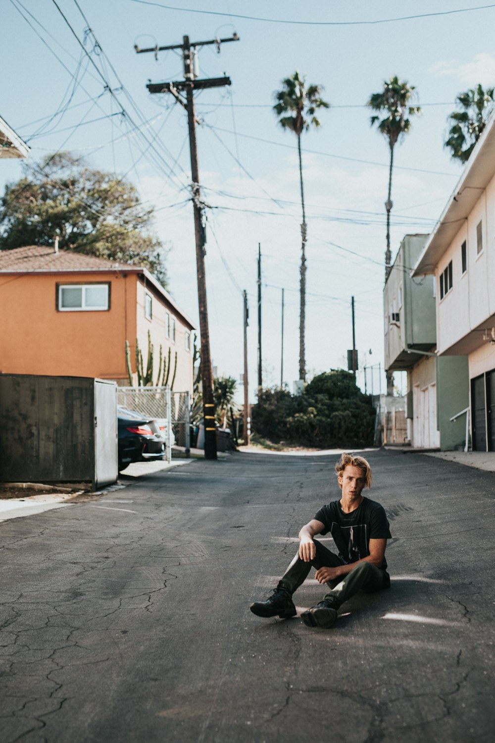 man sitting on pavement