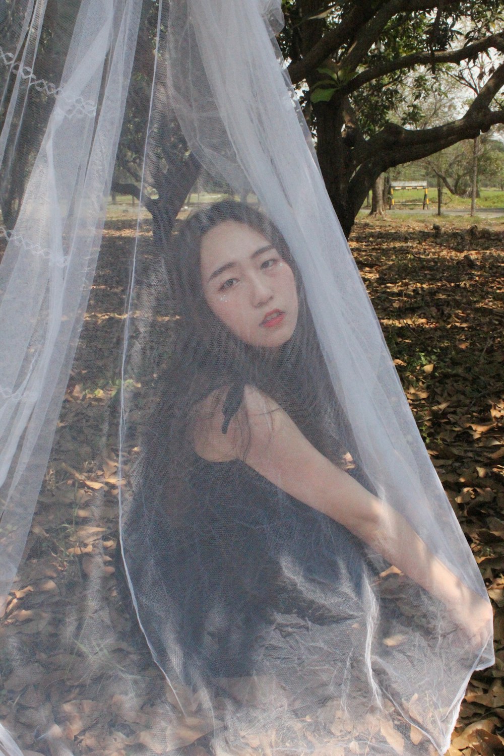 woman covered with white sheer cloth