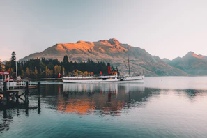 Faded sepia-toned postcard featuring a steamship cutting through misty waters.