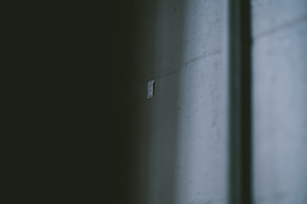 a light switch on a wall in a dark room