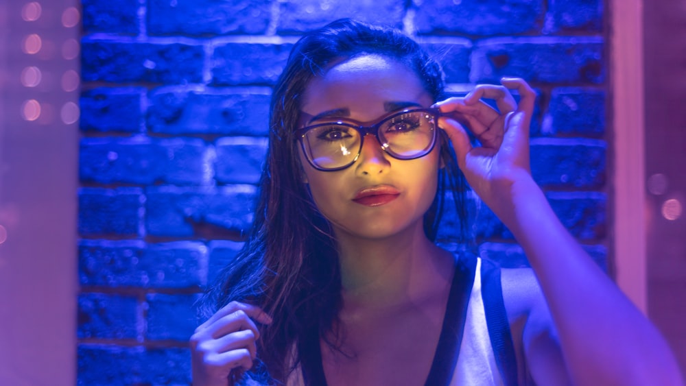 woman holding eyeglasses