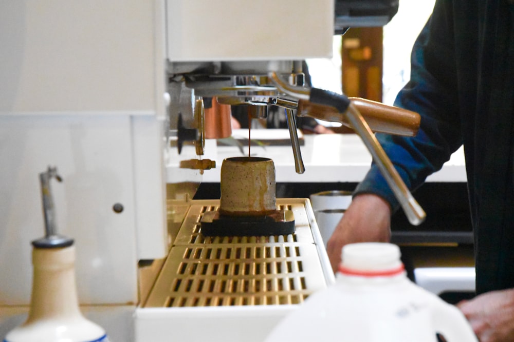 man preparing coffee from coffee machine