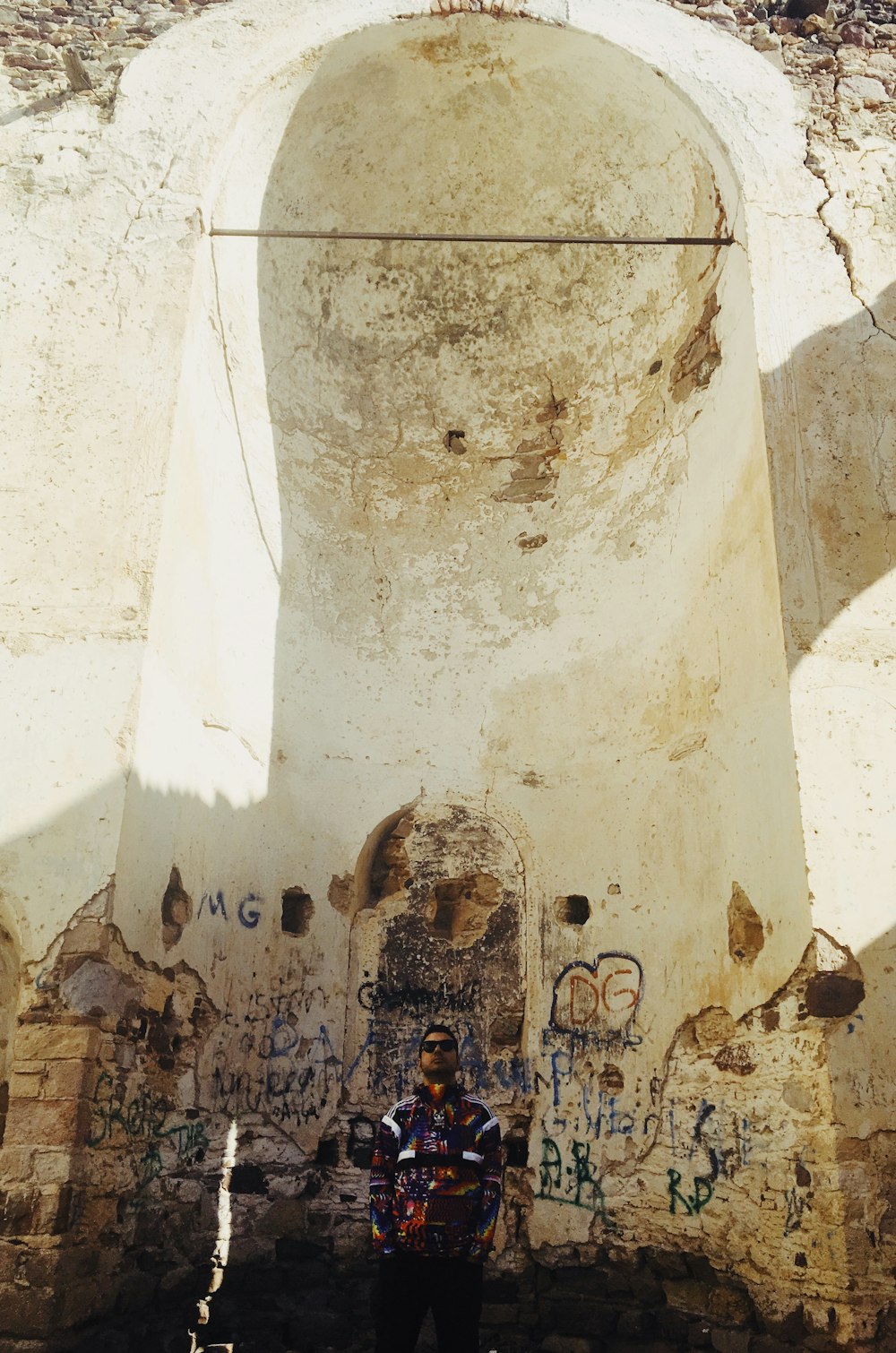 man standing near painted wall