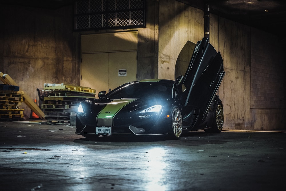 black sports car with open door parking near building