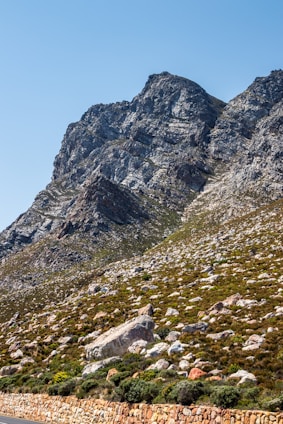 A rugged Patagonian mountain landscape with a sturdy gabion wall blending naturally into the environment.