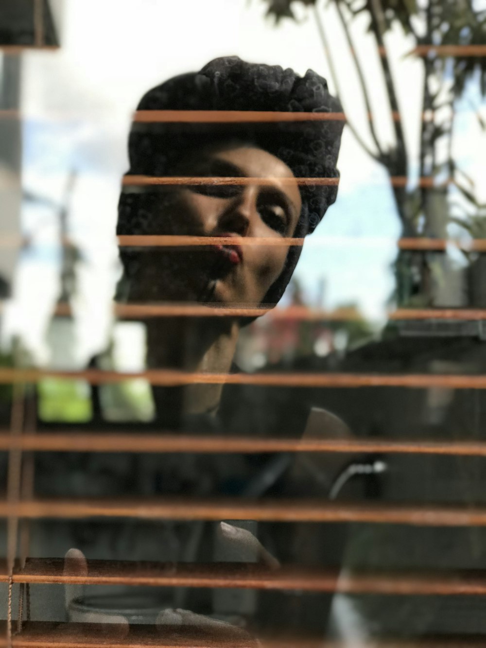 woman standing in front window