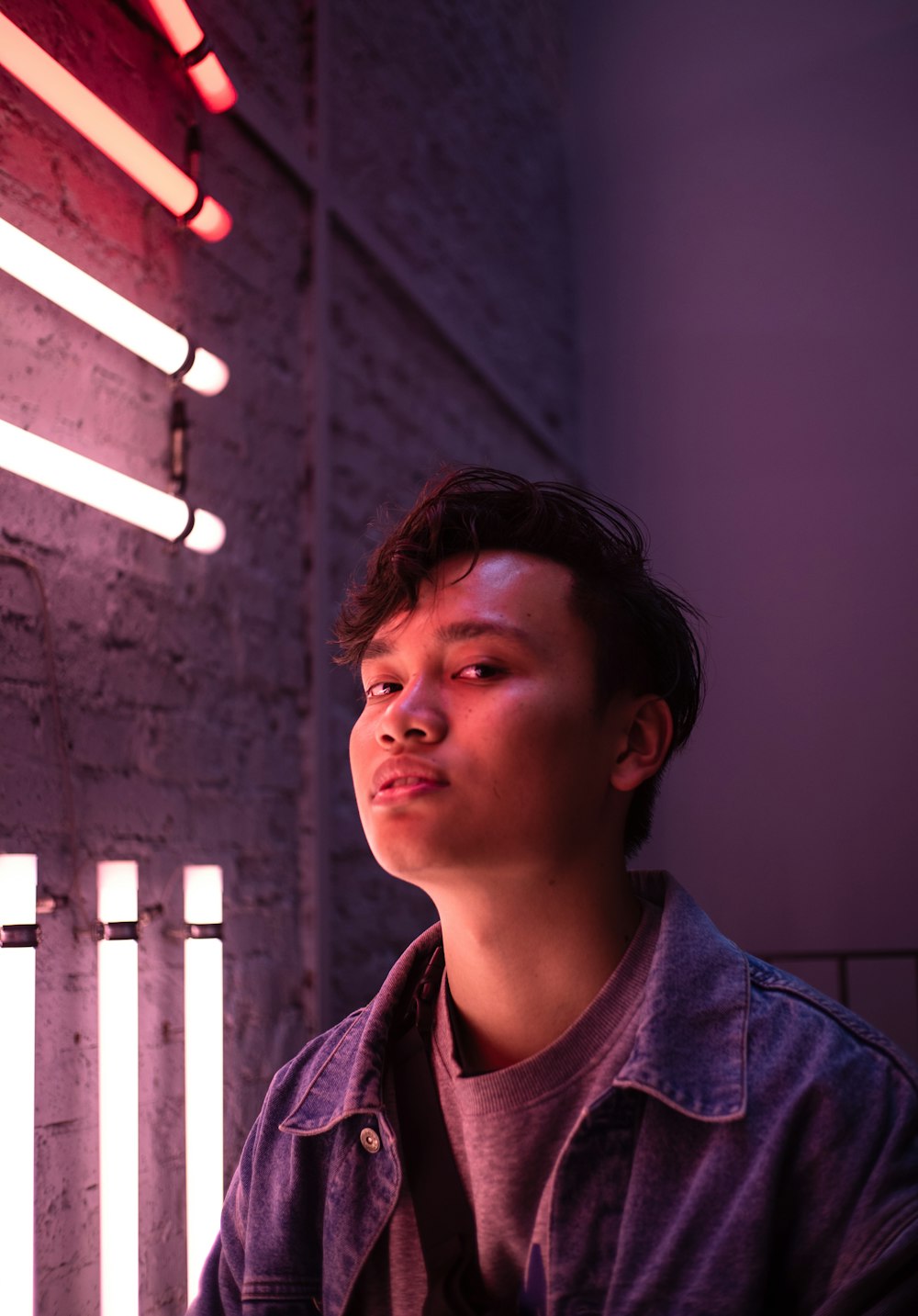 man standing beside fluorescent light