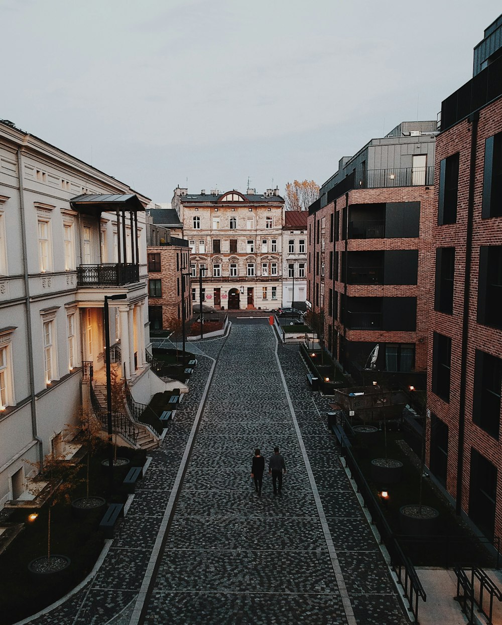 two persons walking on road