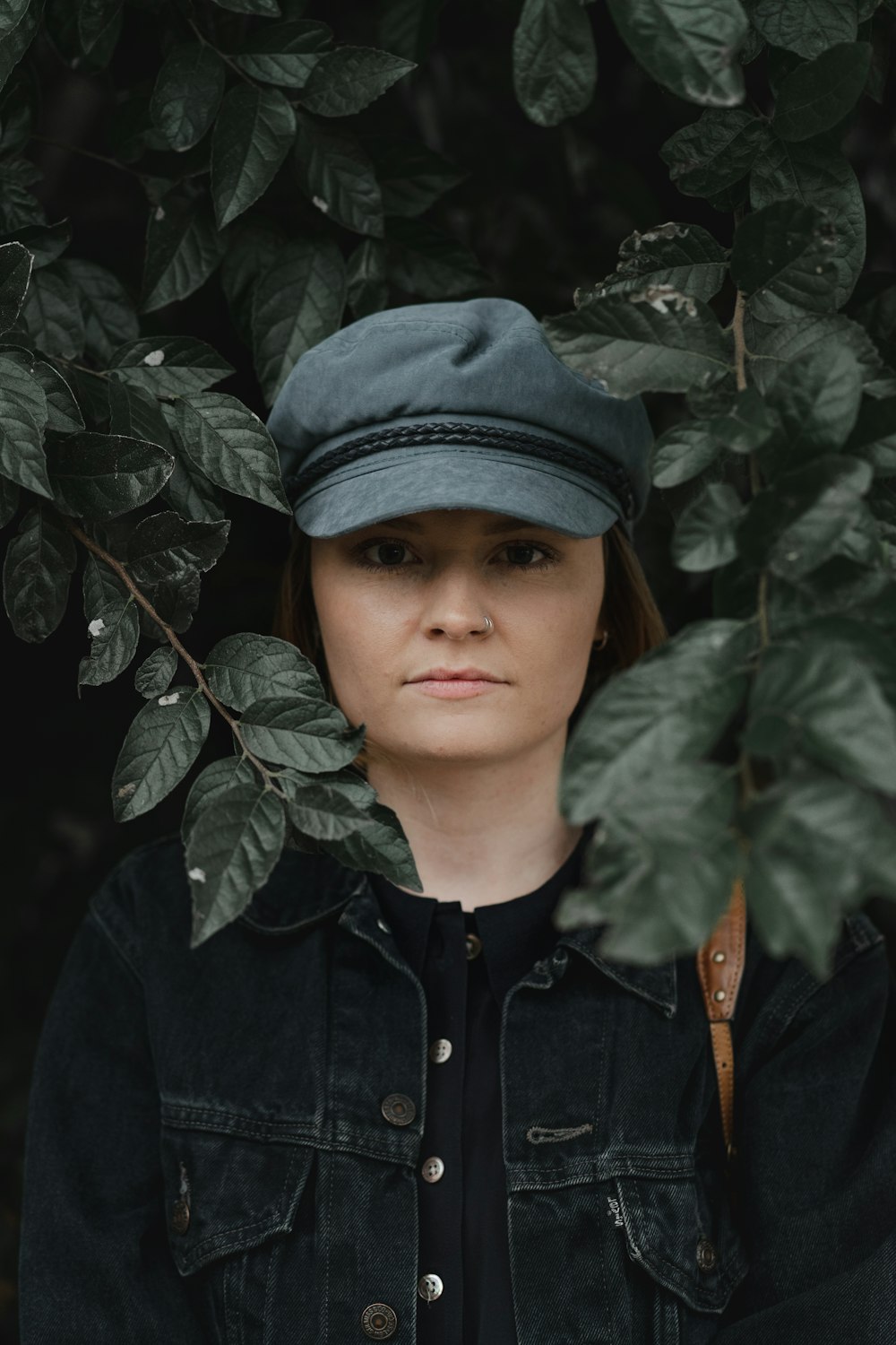 woman surrounded green-leafed plant