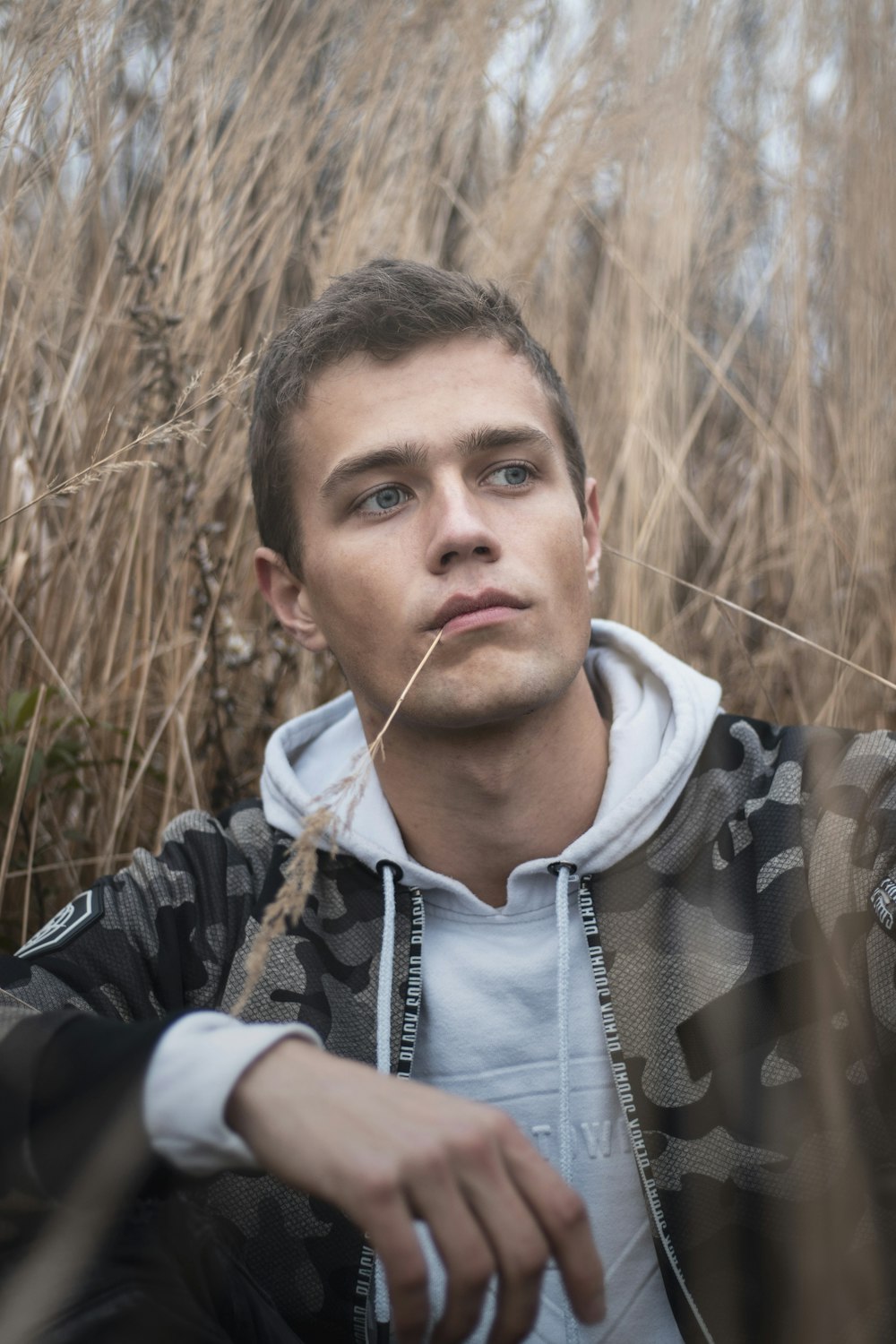 man surrounded by grass