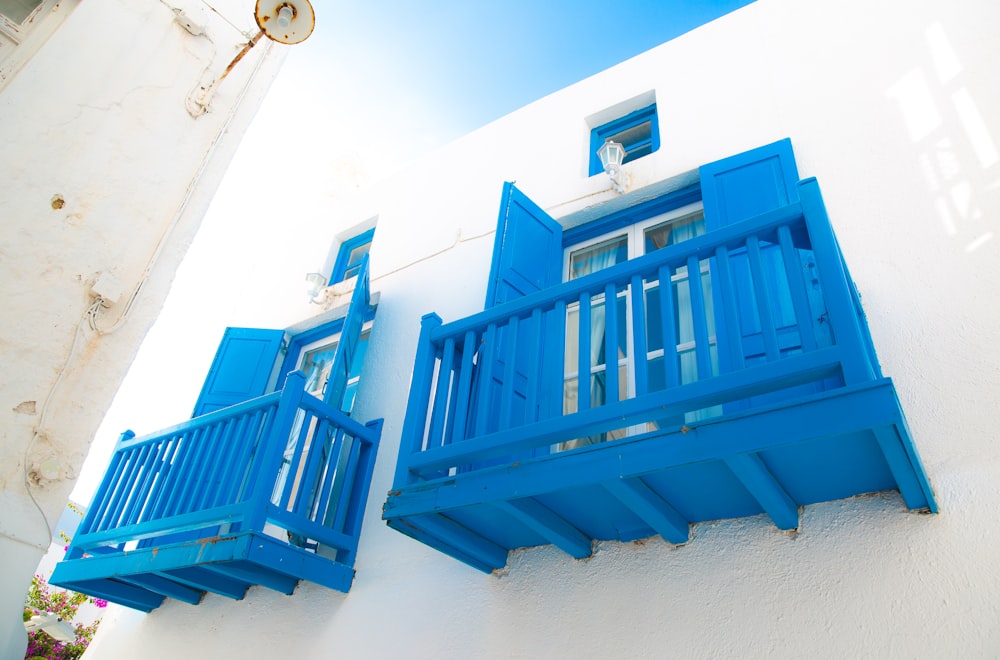 white building with two blue balconies