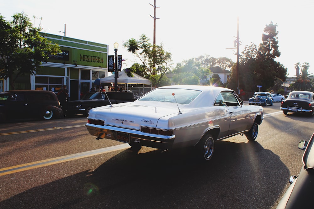 silver coupe on road at daytime