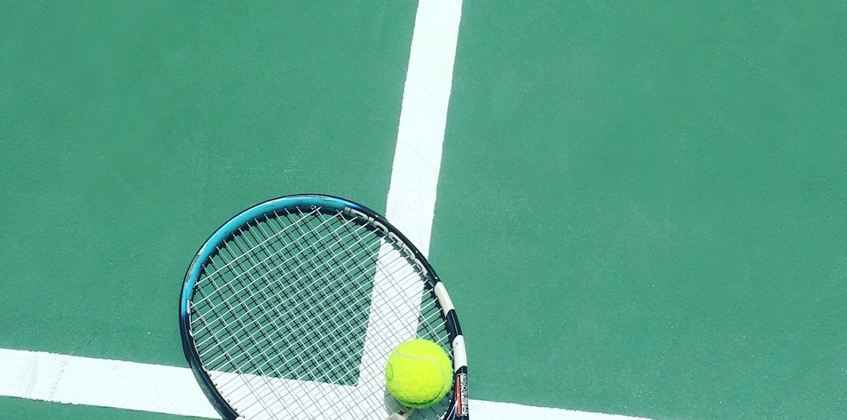 tennis racket and ball on field