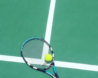 tennis racket and ball on field