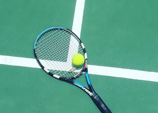 tennis racket and ball on field