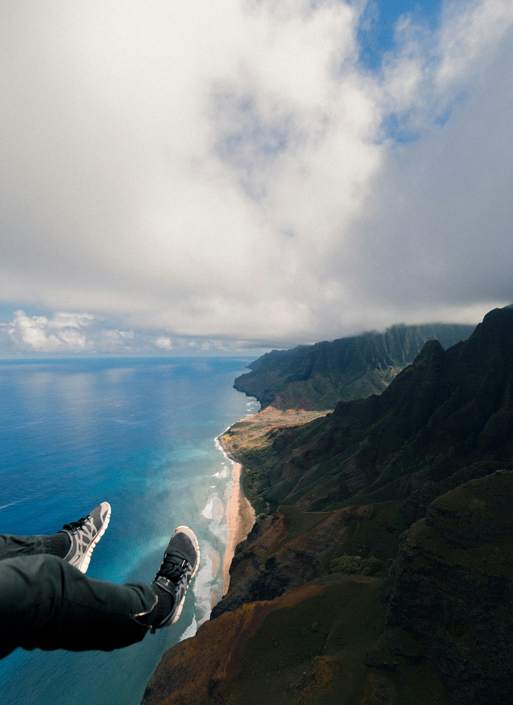 high angle photography of mountains beside ocean