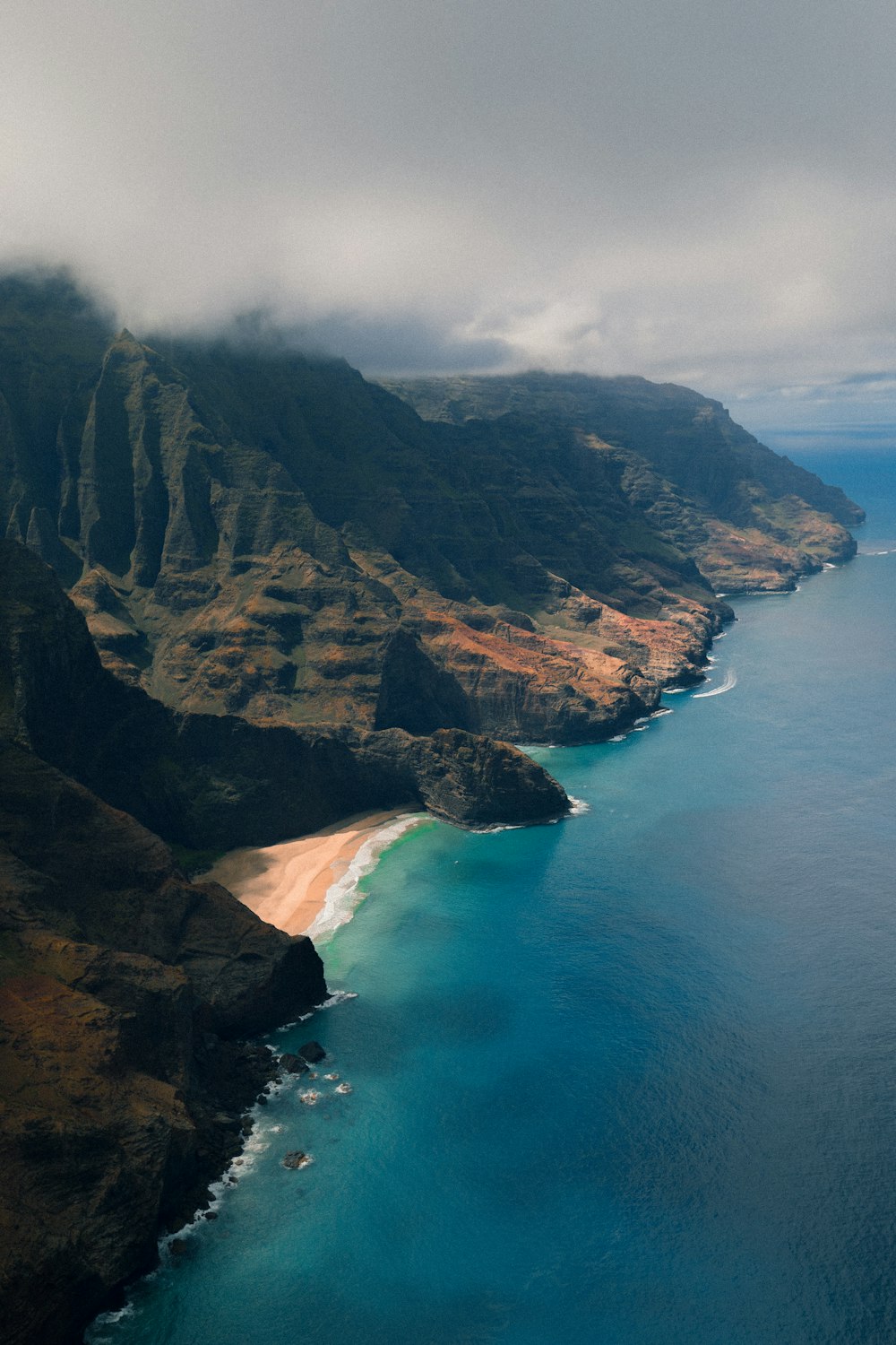 aerial photography of island under cloudy sky