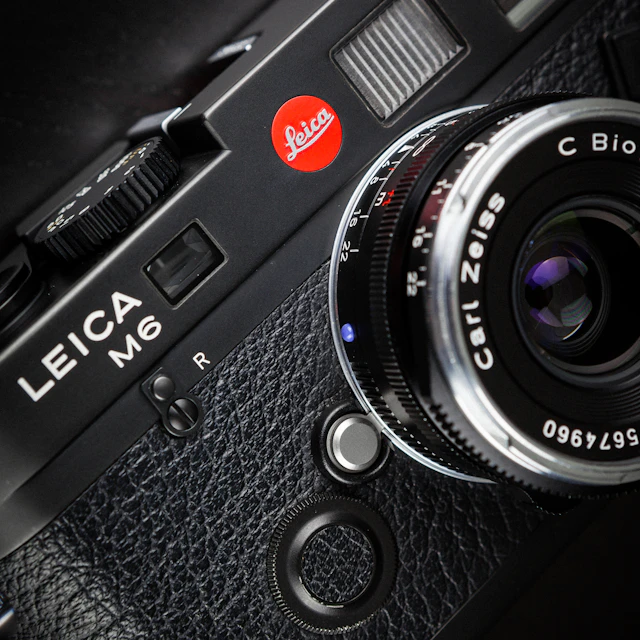 Black Leica M6 rangefinder film camera with lens, shot with shallow depth of field and film grain