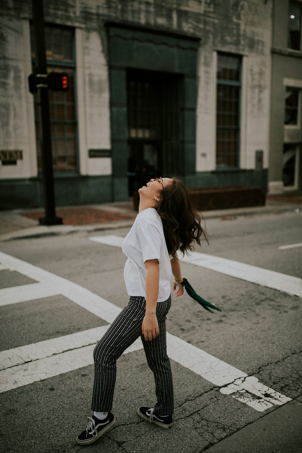 woman standing on road's pedestrian lane