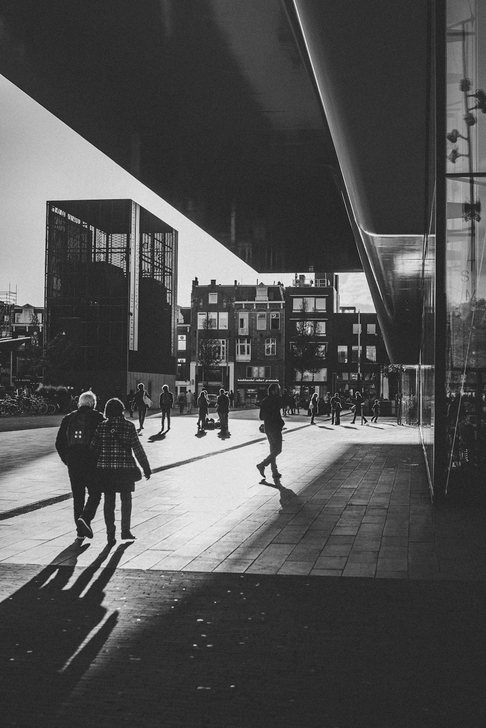 greyscale photography of people beside building