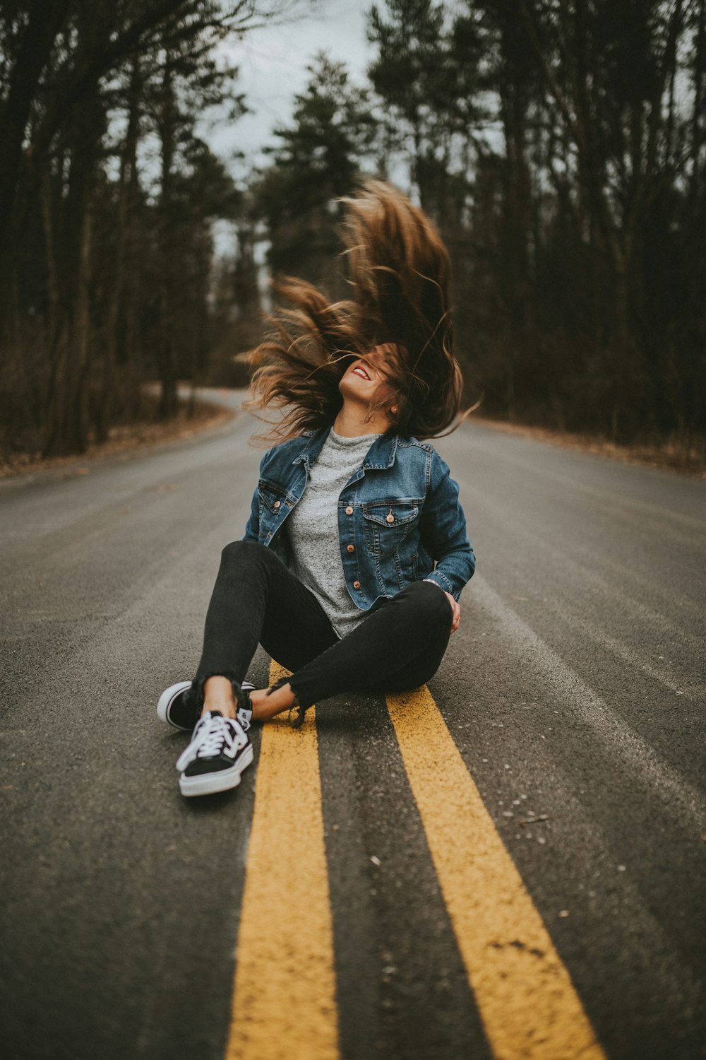 woman sitting on road