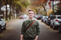 Man in glasses and a green shirt smiling