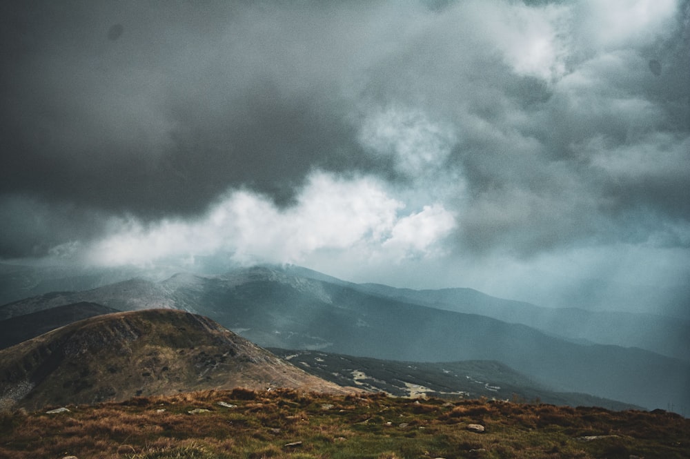 selective focus photography of mountain under cloudy sky during daytime