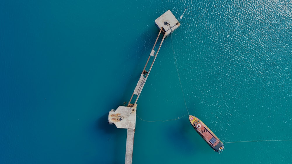 aerial photography of boat approaching bridge