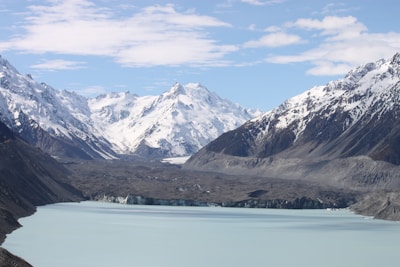 A breathtaking view of the turquoise glacial lakes surrounded by snow-capped peaks in Argentine Patagonia at sunrise.