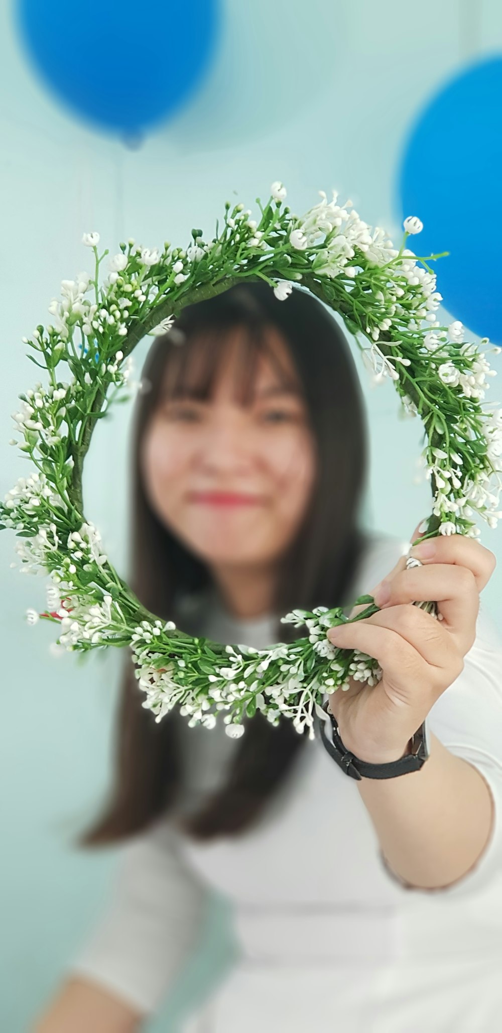 woman holding green wreath