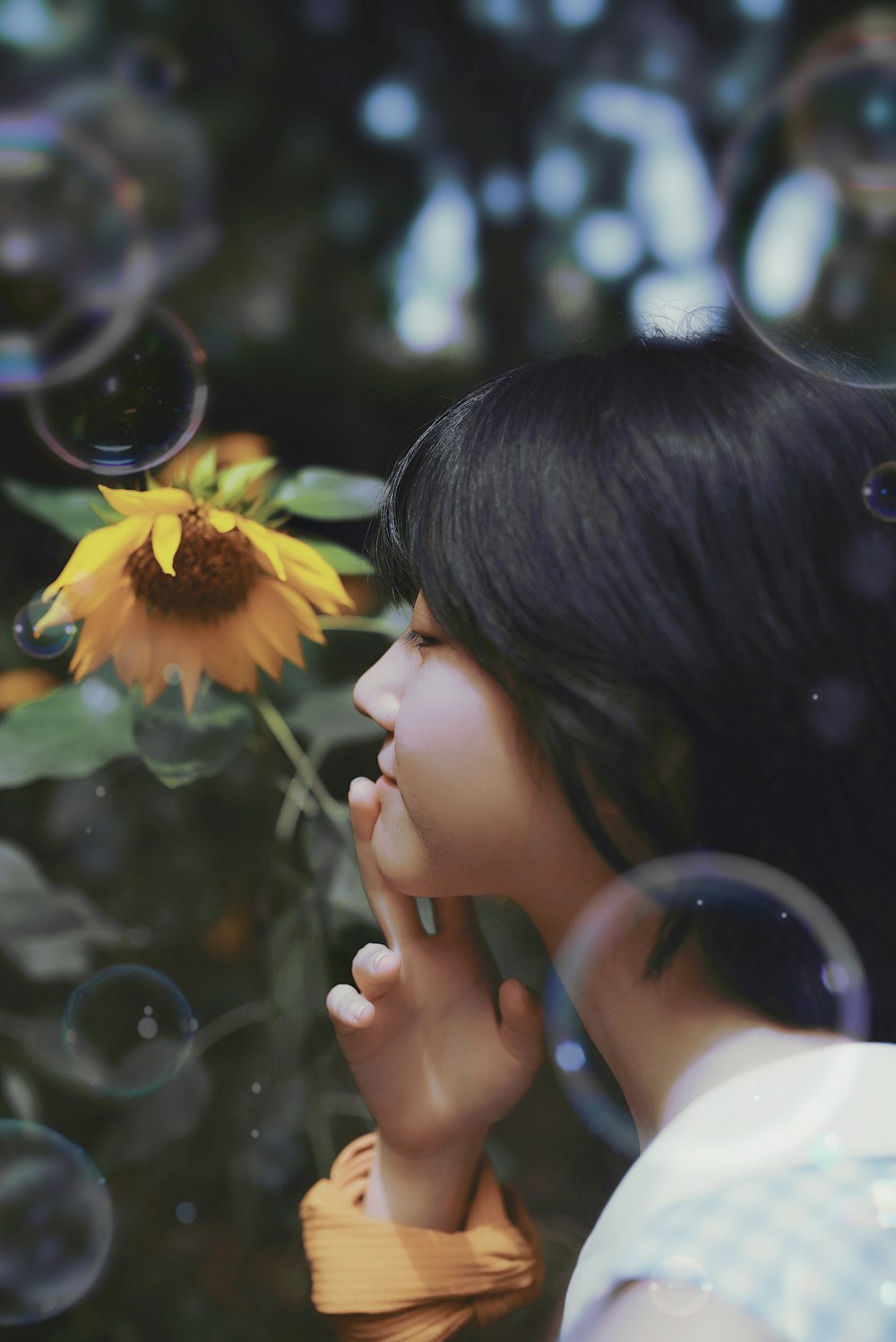 woman smelling yellow sunflower