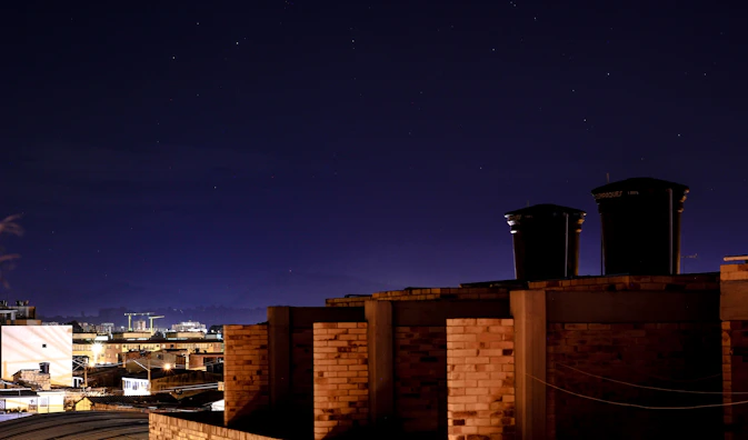Night view of the water tanker truck with city lights of Riyadh in the background.