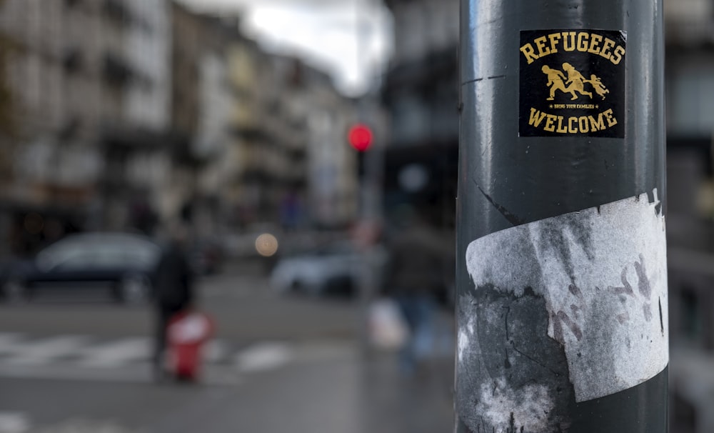 selective-focus photography of Refugees Welcome rod