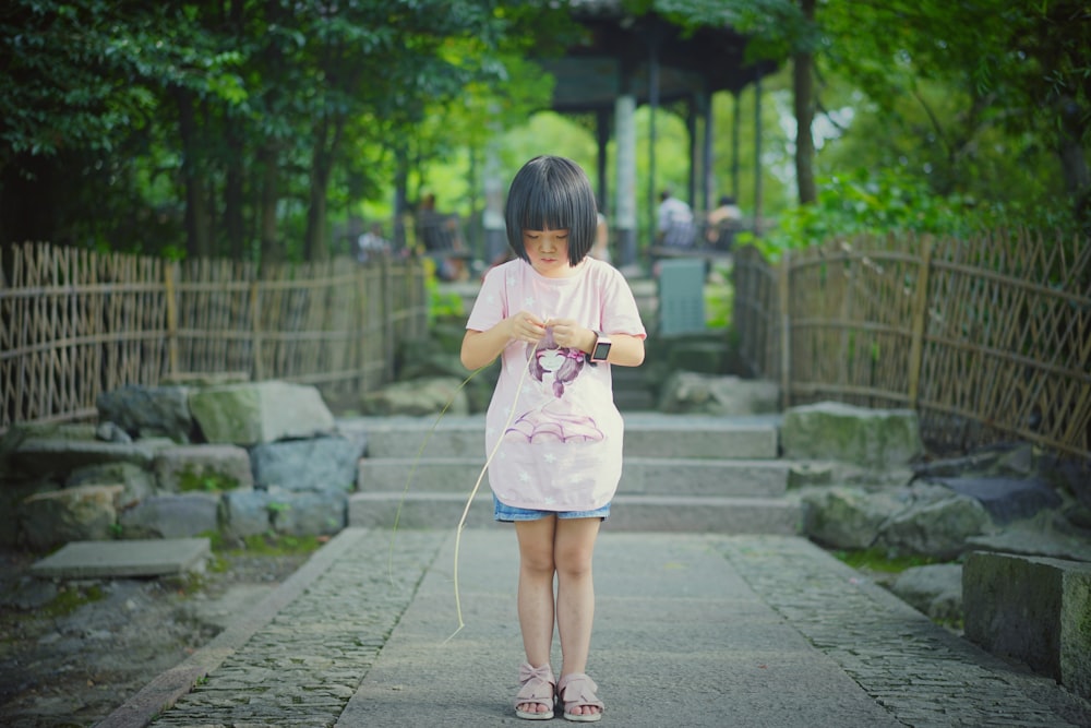 girl holding twig