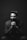 grayscale photography of sitting man wearing suit