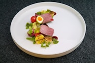 cooked food and vegetables on white plate