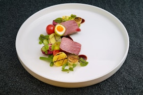 cooked food and vegetables on white plate