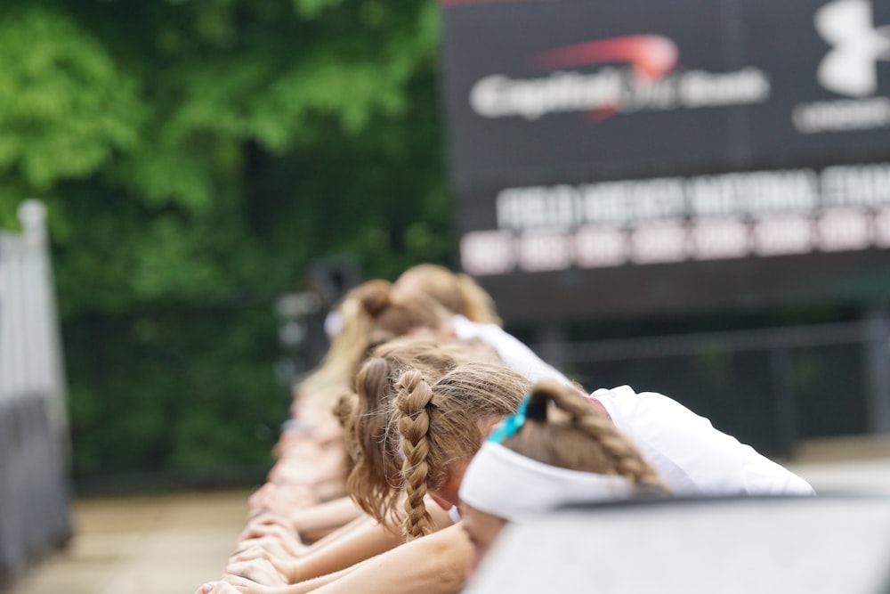 people leaning on railing