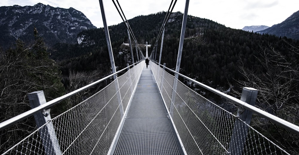 person walking on bridge