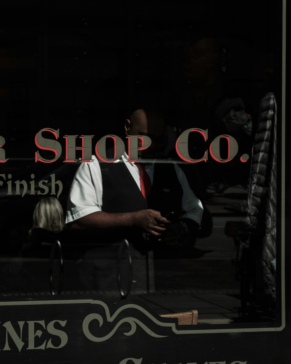 a man standing in front of a barber shop