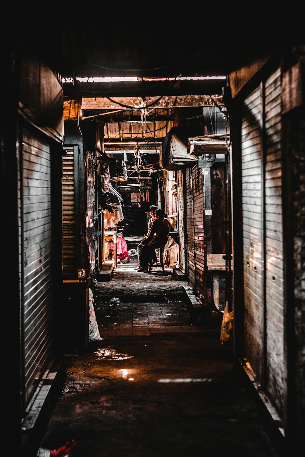 person sitting on chair near roller shutter