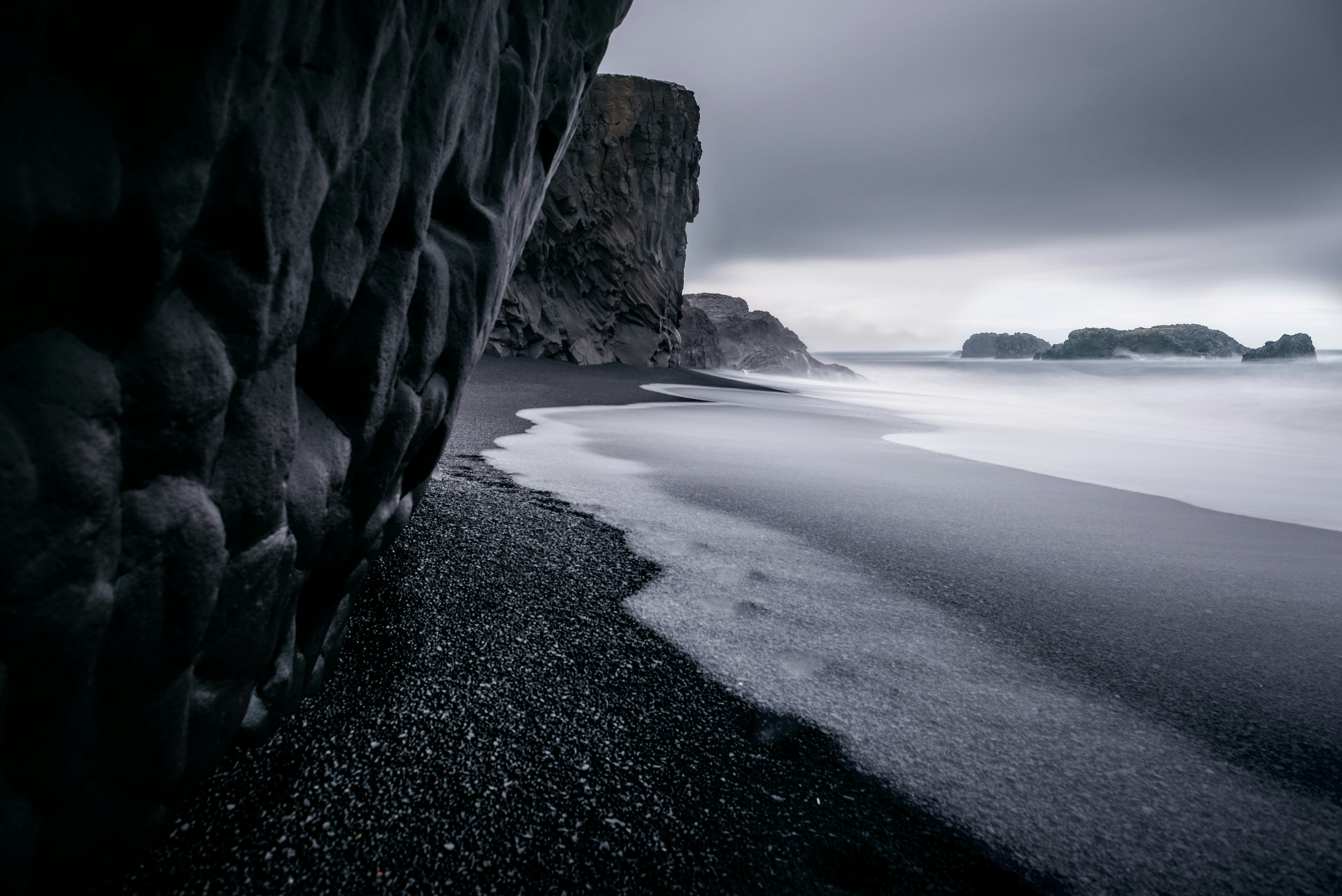 grayscale photography of seashore and calm sea