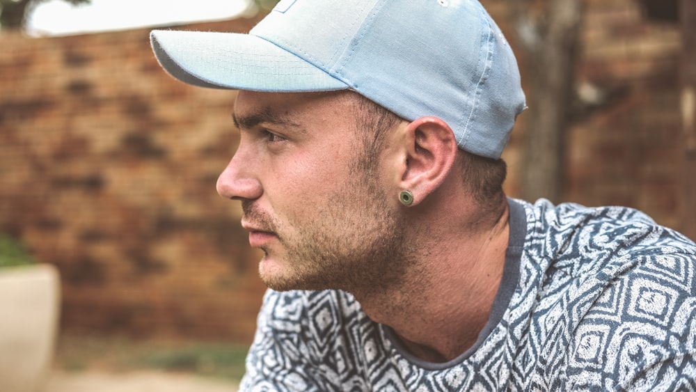 selective focus photo of man wearing white and black crew-neck top