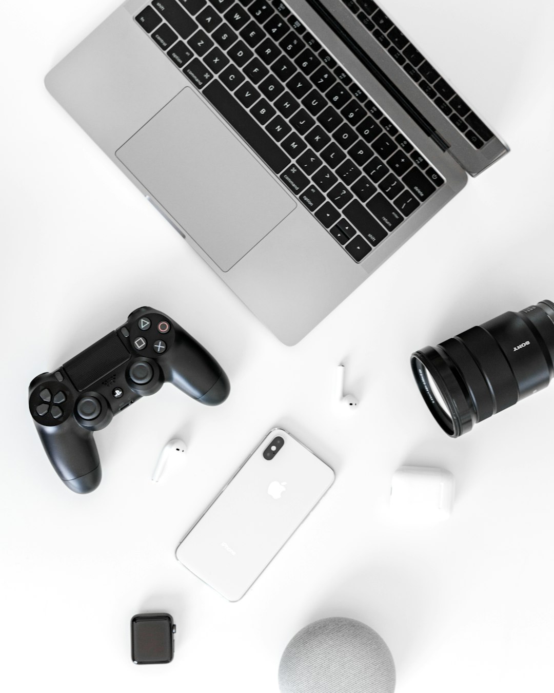 black Sony DualShock 4 and MacBook Pro