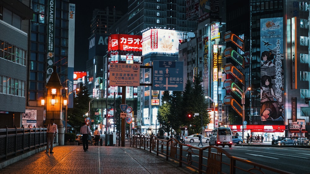 a city street at night with tall buildings