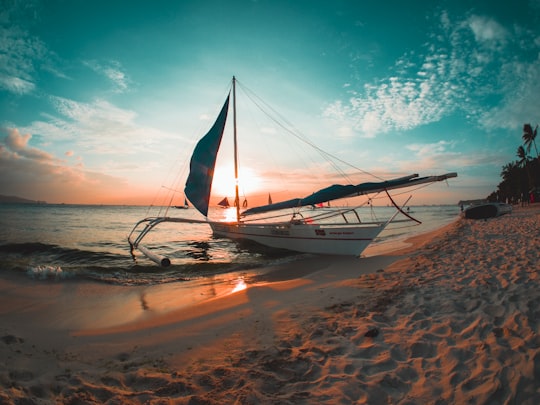 white boat docked on seashore in Boracay Philippines