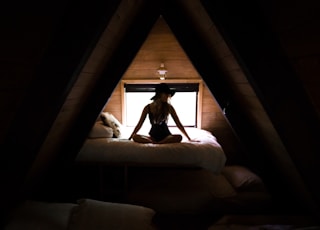 silhouette photography of woman sitting on bed