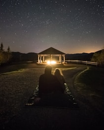 A couple enjoying a romantic dinner on their villa’s deck under a starlit sky.