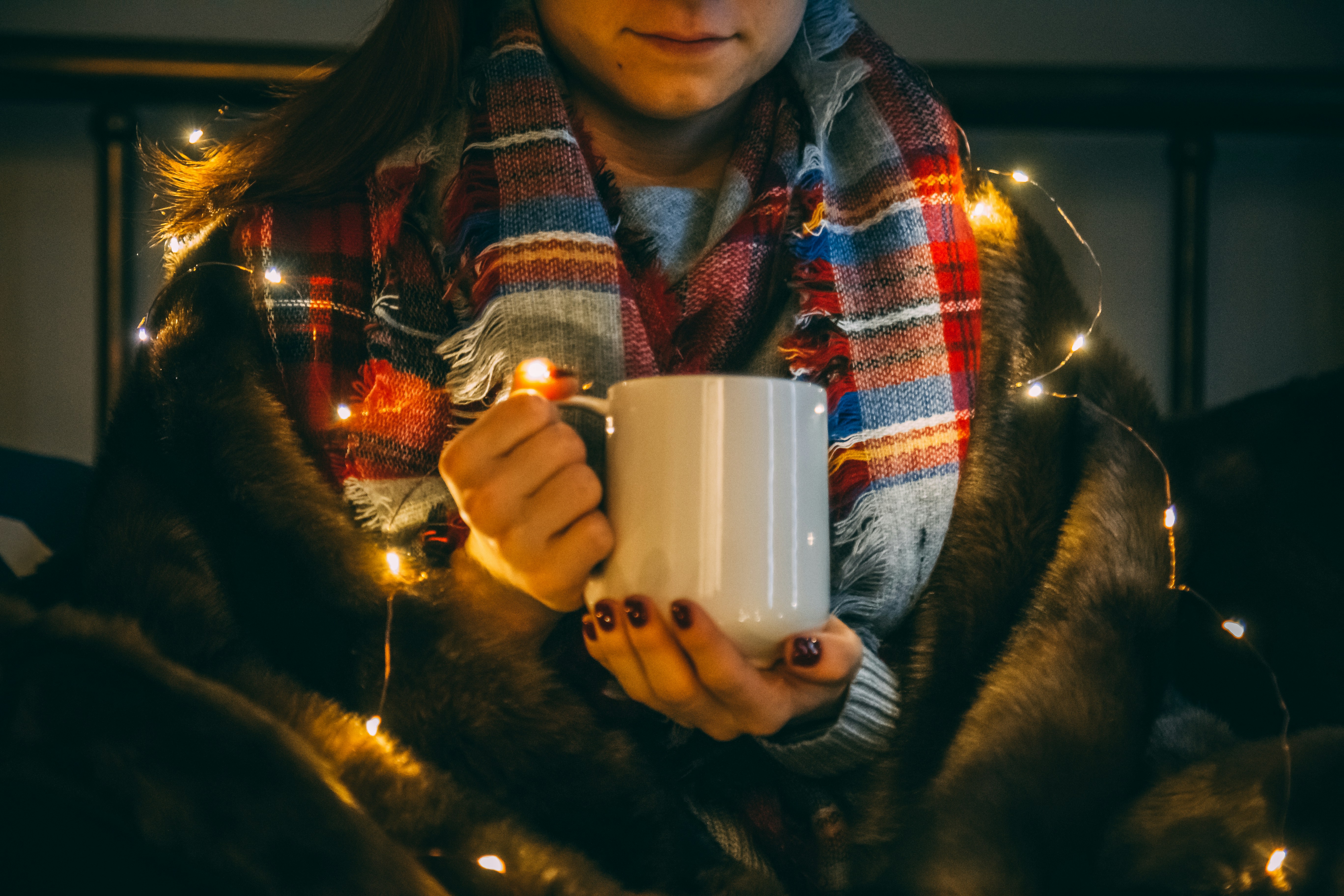 shallow focus photo of person wearing white ceramic mug