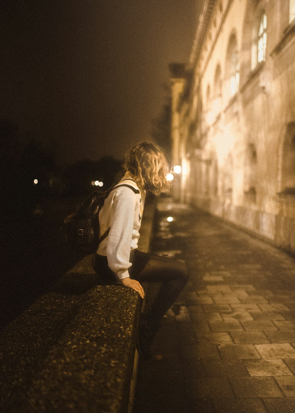 woman sitting near river